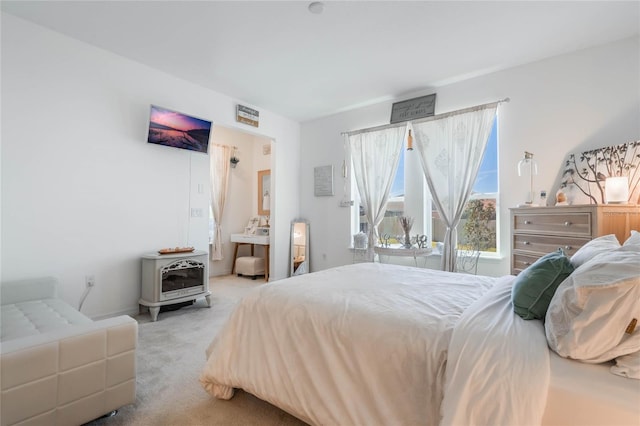 carpeted bedroom featuring a wood stove