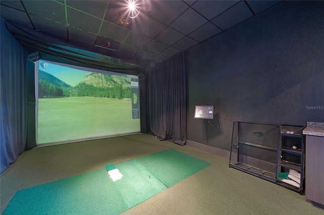 game room featuring golf simulator, carpet flooring, and a paneled ceiling