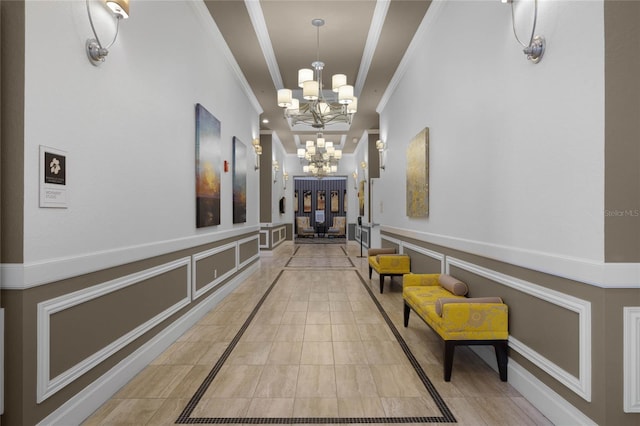 hallway featuring an inviting chandelier and crown molding