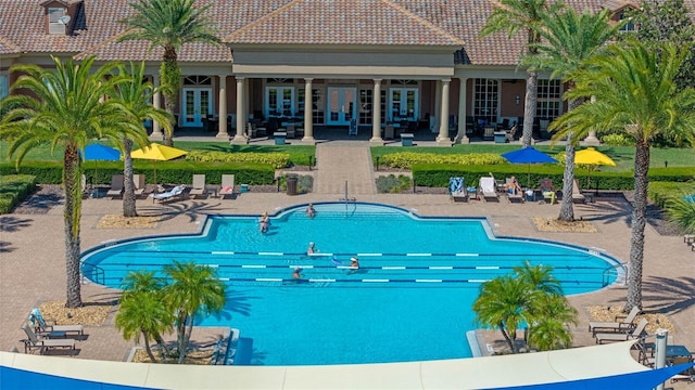 view of swimming pool with a patio area and french doors