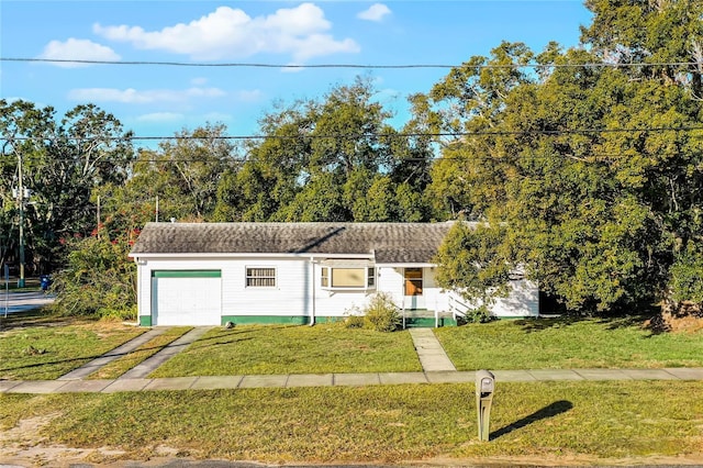 view of front of house with a garage and a front lawn