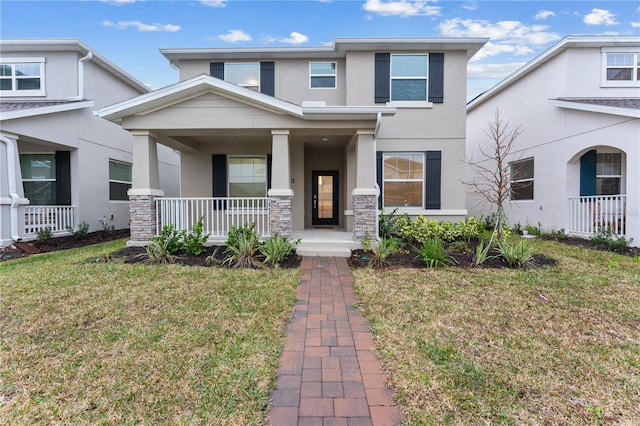 view of front of house with a front yard and a porch