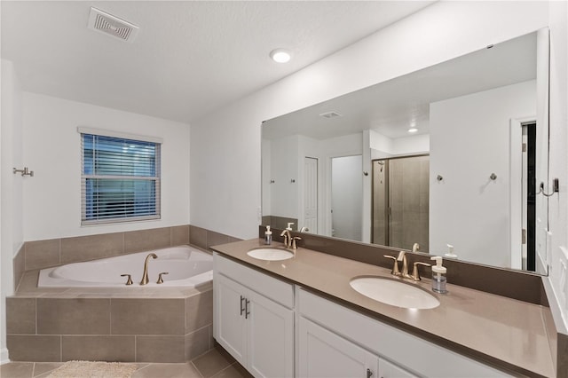 bathroom featuring vanity, shower with separate bathtub, and tile patterned flooring