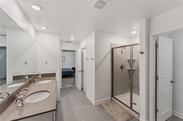 bathroom featuring walk in shower, tile patterned floors, vanity, and a textured ceiling