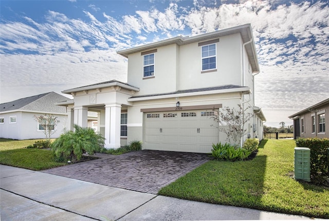 view of front of property with a garage and a front lawn