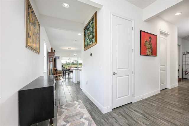 hallway with hardwood / wood-style flooring