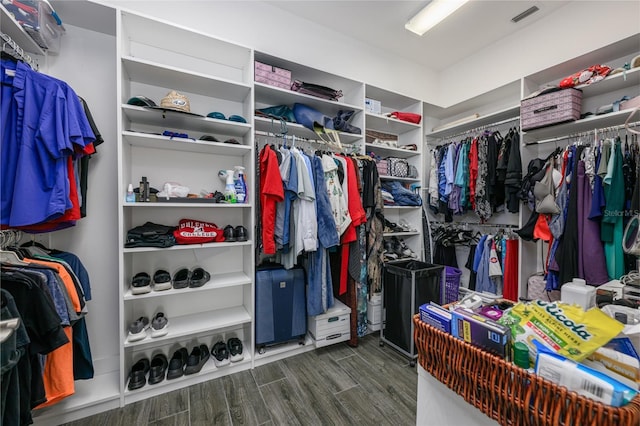 walk in closet with dark hardwood / wood-style floors