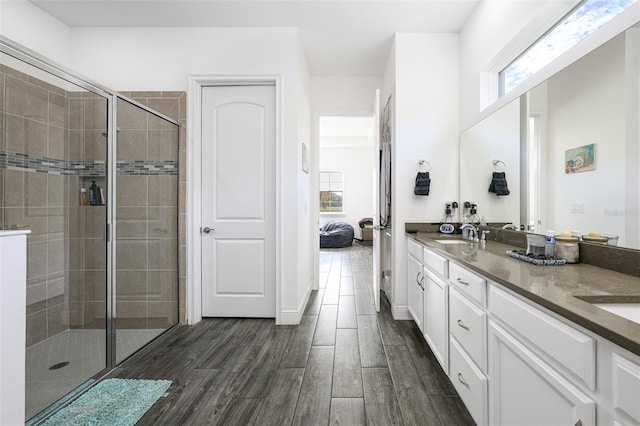 bathroom with vanity, an enclosed shower, and hardwood / wood-style flooring