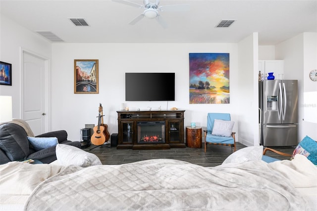 living room with dark hardwood / wood-style floors and ceiling fan