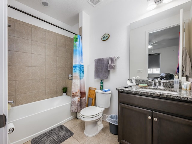 full bathroom with shower / bathtub combination with curtain, vanity, tile patterned floors, and toilet