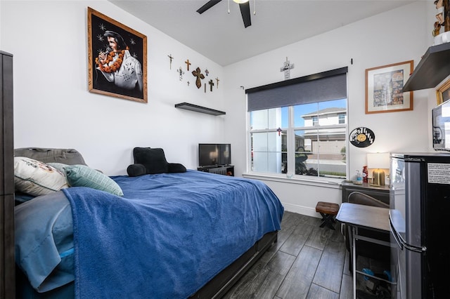 bedroom with dark hardwood / wood-style floors and ceiling fan