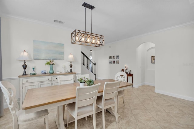 dining room featuring light tile patterned floors and crown molding