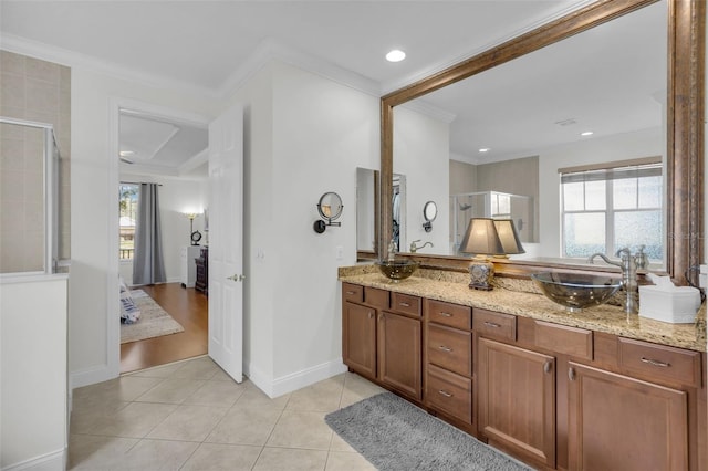 bathroom with crown molding, tile patterned floors, vanity, and a wealth of natural light