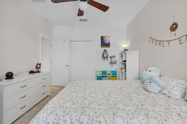 bedroom with light carpet, ceiling fan, and a closet