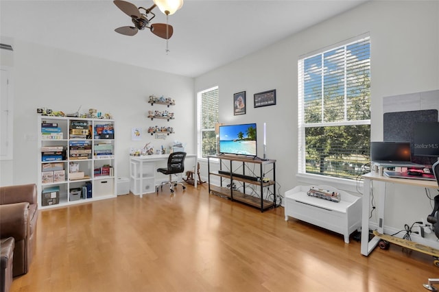 office area with hardwood / wood-style flooring, a wealth of natural light, and ceiling fan