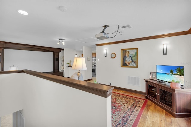 corridor featuring crown molding and light wood-type flooring