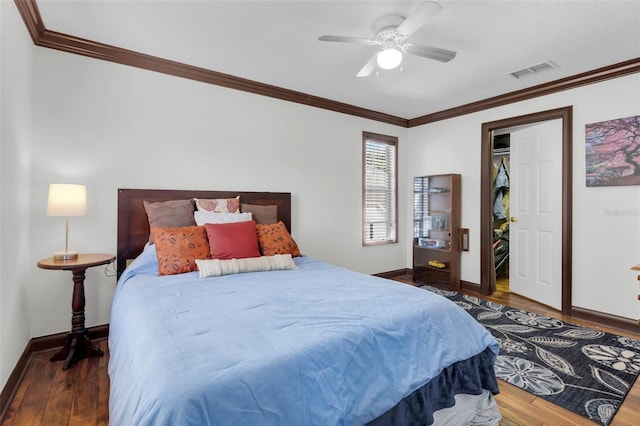 bedroom with hardwood / wood-style flooring, ceiling fan, and crown molding