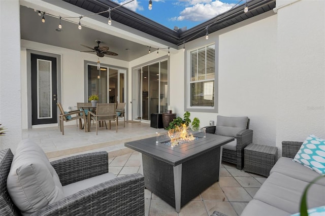 view of patio / terrace with an outdoor living space with a fire pit and ceiling fan