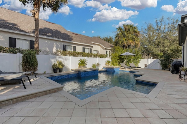 view of pool featuring a patio area and an in ground hot tub