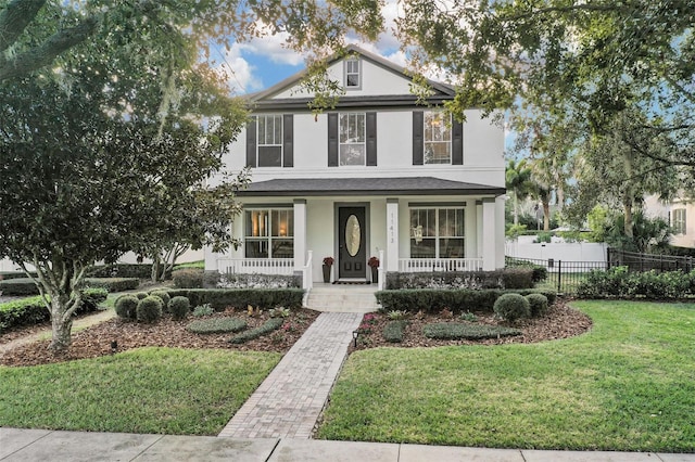 view of front of house with a porch and a front lawn