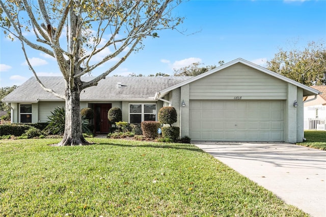 ranch-style home featuring a garage and a front lawn