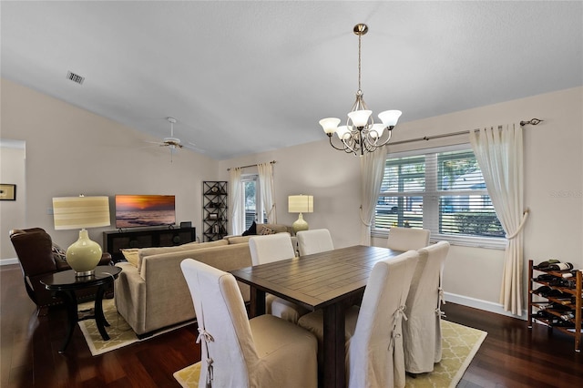 dining area with lofted ceiling, ceiling fan with notable chandelier, and dark hardwood / wood-style flooring