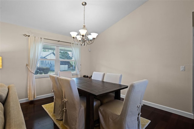 dining space featuring lofted ceiling, dark hardwood / wood-style floors, and an inviting chandelier