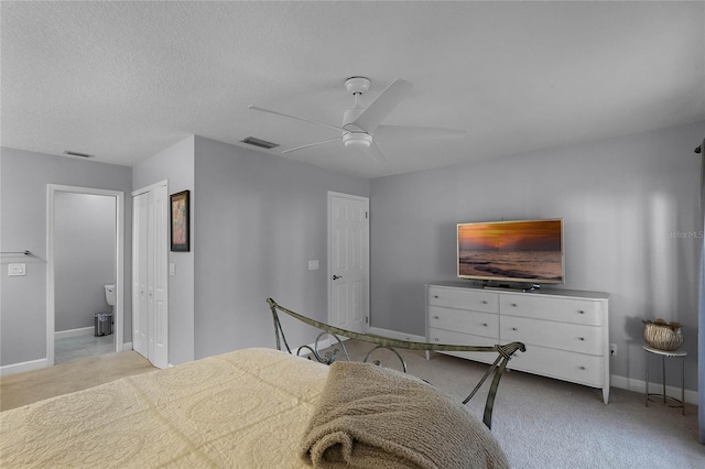 carpeted bedroom featuring ceiling fan, a textured ceiling, and a closet