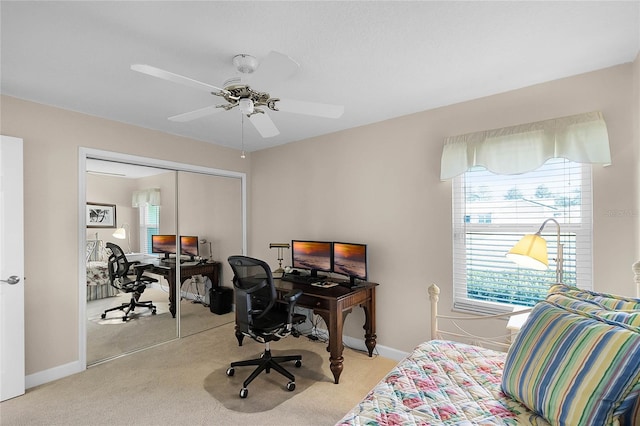 office featuring ceiling fan and light carpet