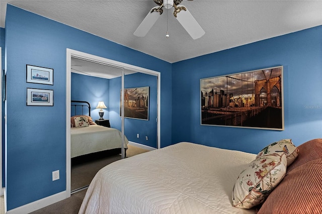 carpeted bedroom featuring ceiling fan, a closet, and a textured ceiling