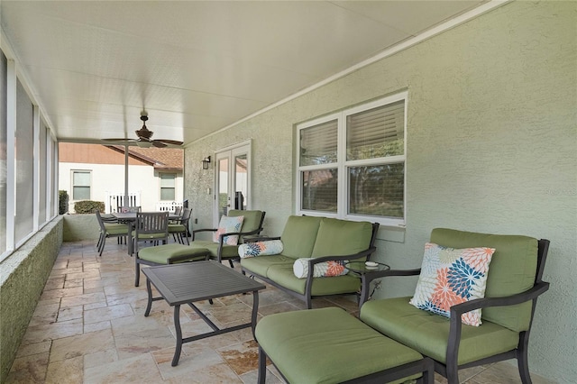 sunroom featuring ceiling fan