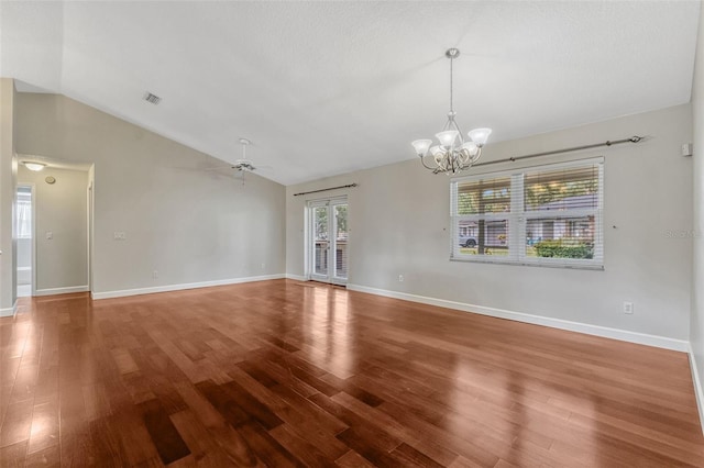 interior space with ceiling fan with notable chandelier, wood finished floors, and vaulted ceiling