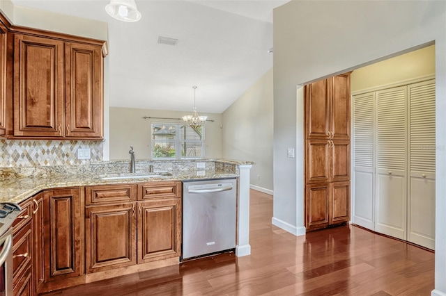 kitchen with visible vents, lofted ceiling, dark wood-style floors, a sink, and dishwasher