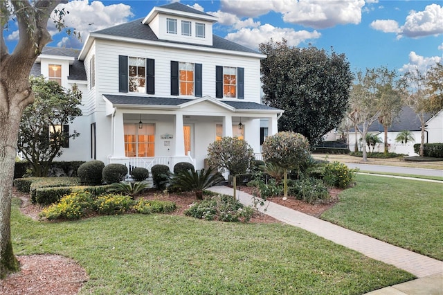 view of front facade with covered porch and a front yard