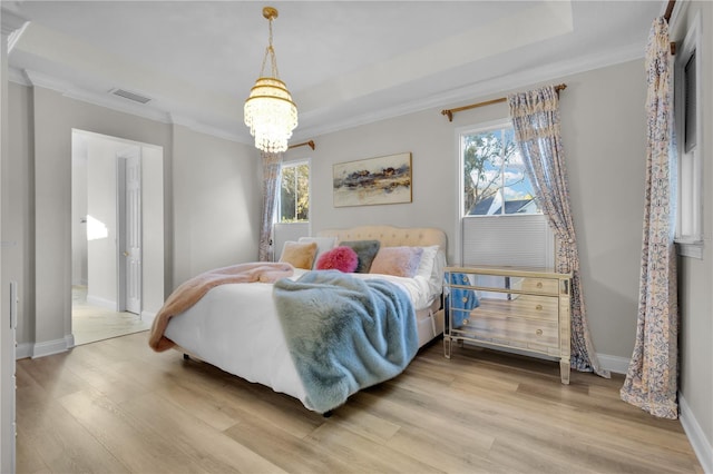 bedroom with crown molding, light hardwood / wood-style floors, and a chandelier