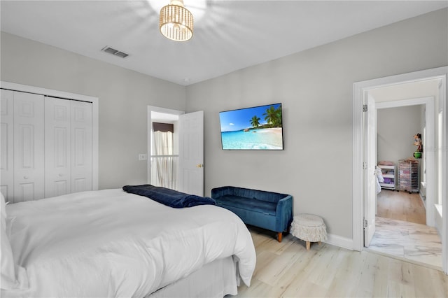 bedroom featuring light hardwood / wood-style flooring and a closet