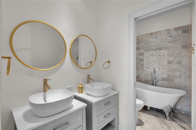 bathroom featuring a bathing tub, vanity, and toilet