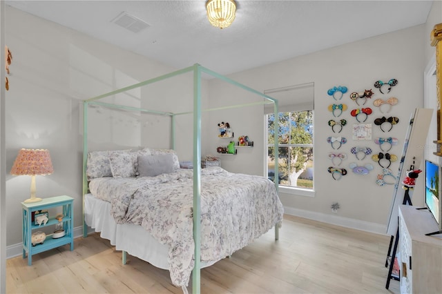 bedroom with hardwood / wood-style flooring