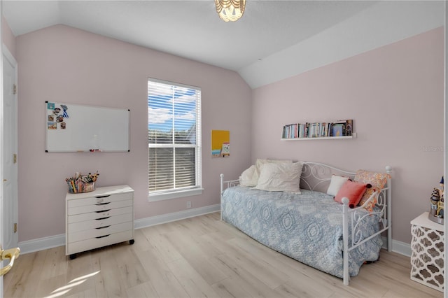 bedroom featuring lofted ceiling and light wood-type flooring