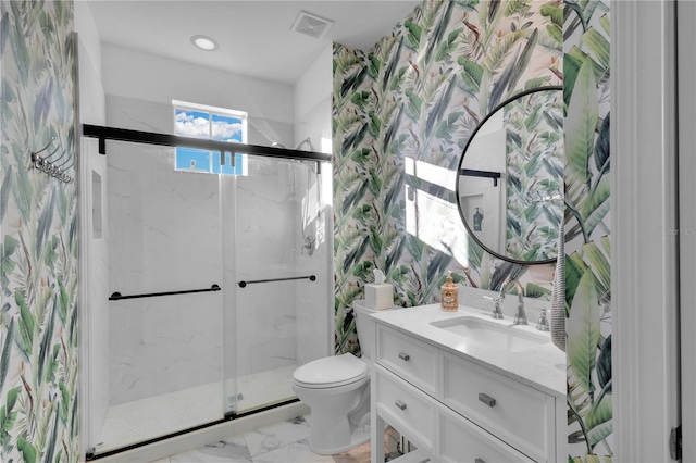 bathroom featuring vanity, a shower with door, and toilet