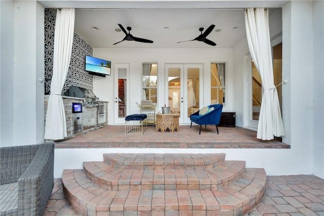 view of patio with grilling area, an outdoor kitchen, and ceiling fan