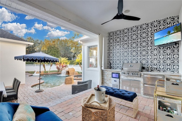 view of patio with a grill, pool water feature, ceiling fan, and exterior kitchen