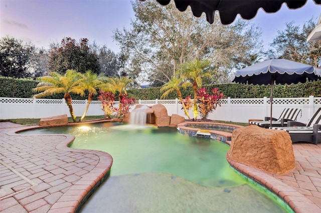 view of swimming pool with a patio area and an in ground hot tub