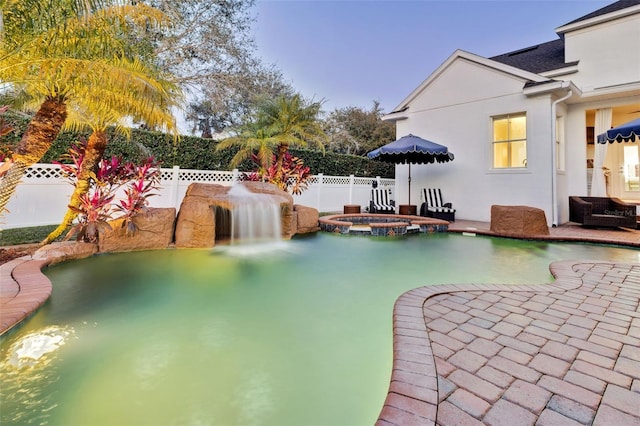 view of pool featuring a patio and an in ground hot tub