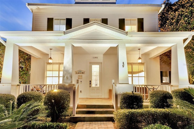 view of exterior entry with covered porch