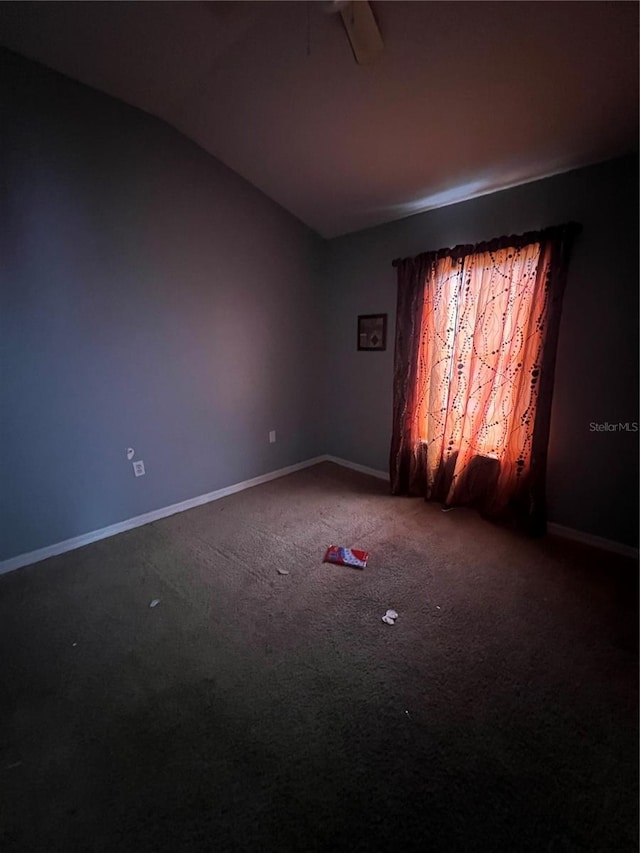 carpeted empty room featuring lofted ceiling