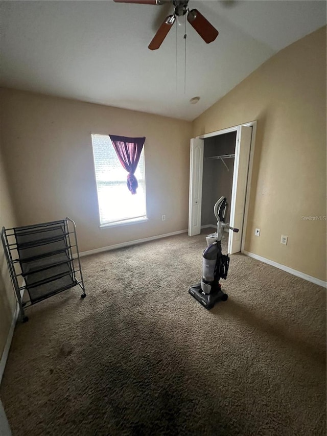 unfurnished bedroom with ceiling fan, lofted ceiling, carpet flooring, and a closet