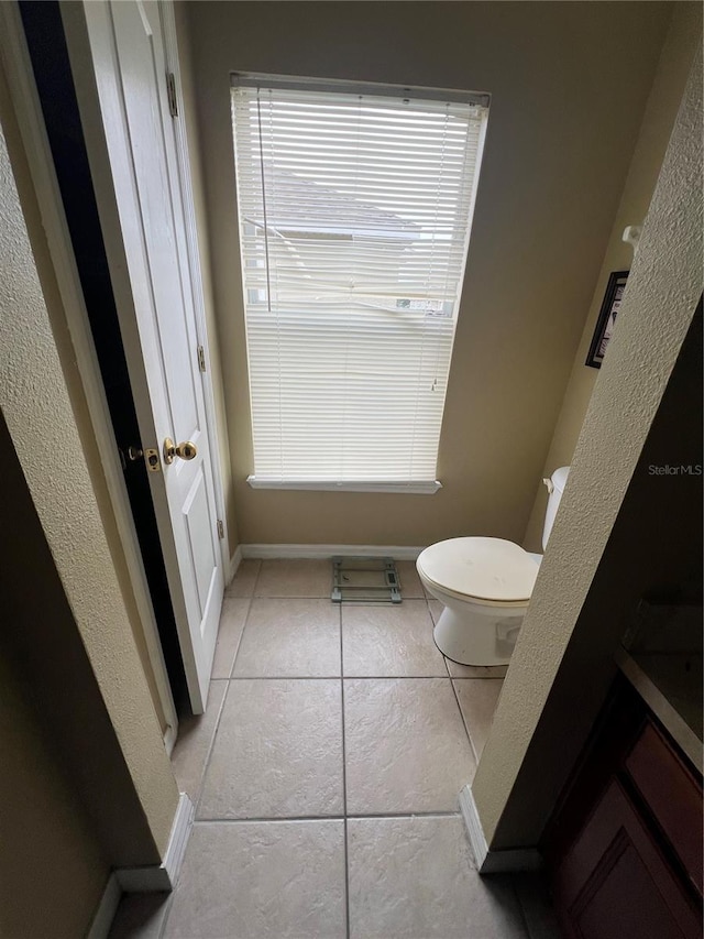 bathroom featuring tile patterned flooring and toilet