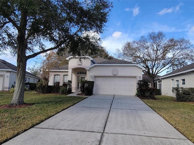 view of front of house featuring a garage and a front lawn