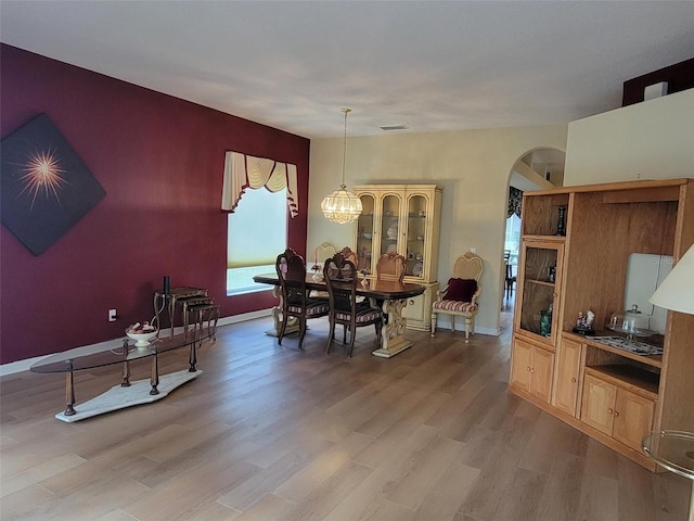 dining area featuring hardwood / wood-style floors and a chandelier